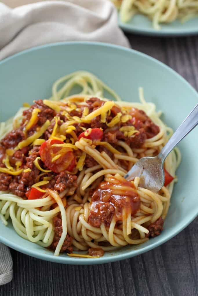 eating Filipino spaghetti with a fork in a bowl