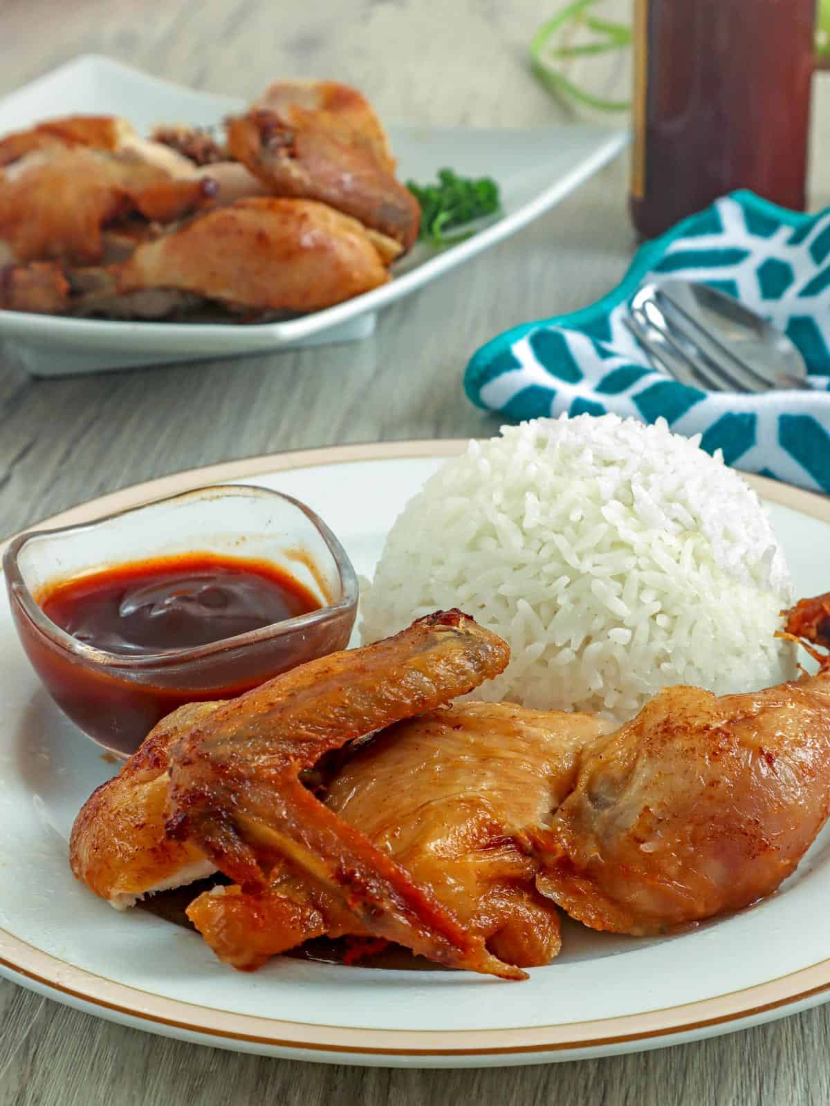 cut-up fried chicken with steamed rice on a white plate