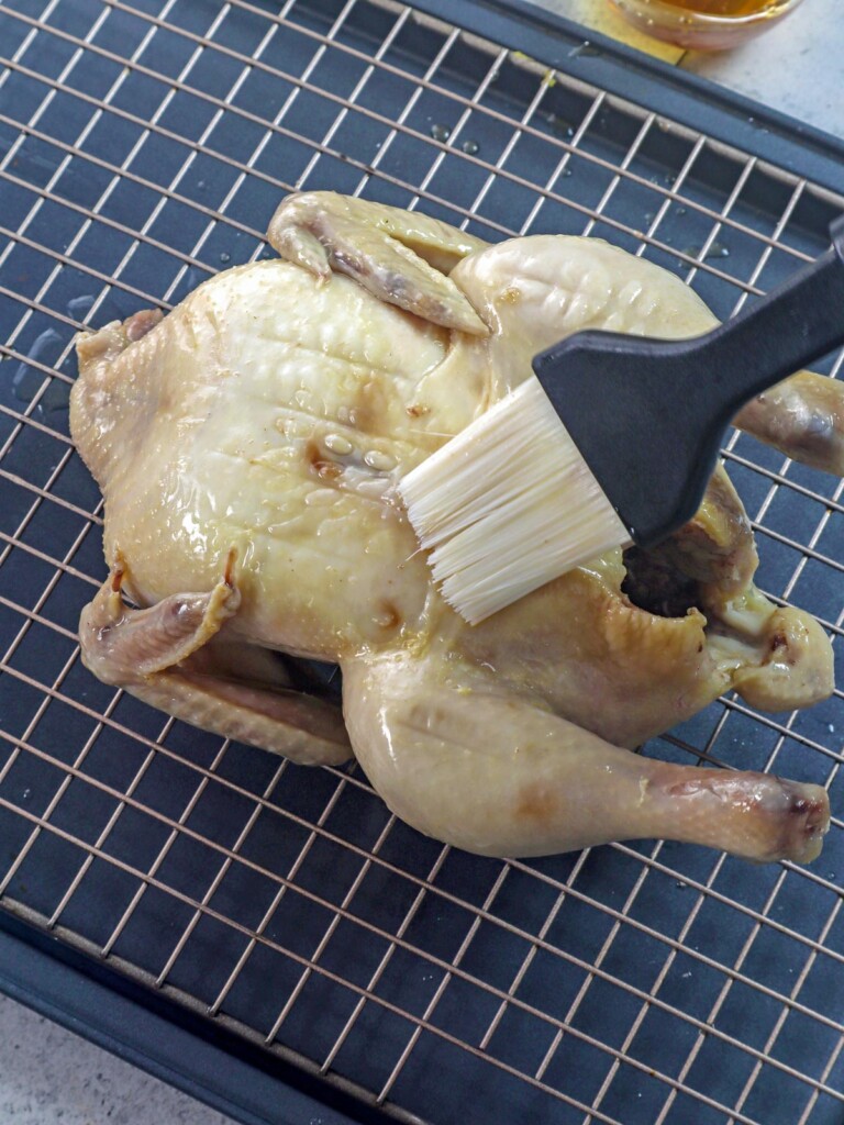 brushing fish sauce on steamed chicken