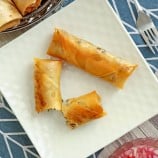 top view of crispy Fish Lumpia on a white square platter