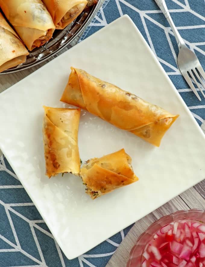 top view of crispy Fish Lumpia on a white square platter