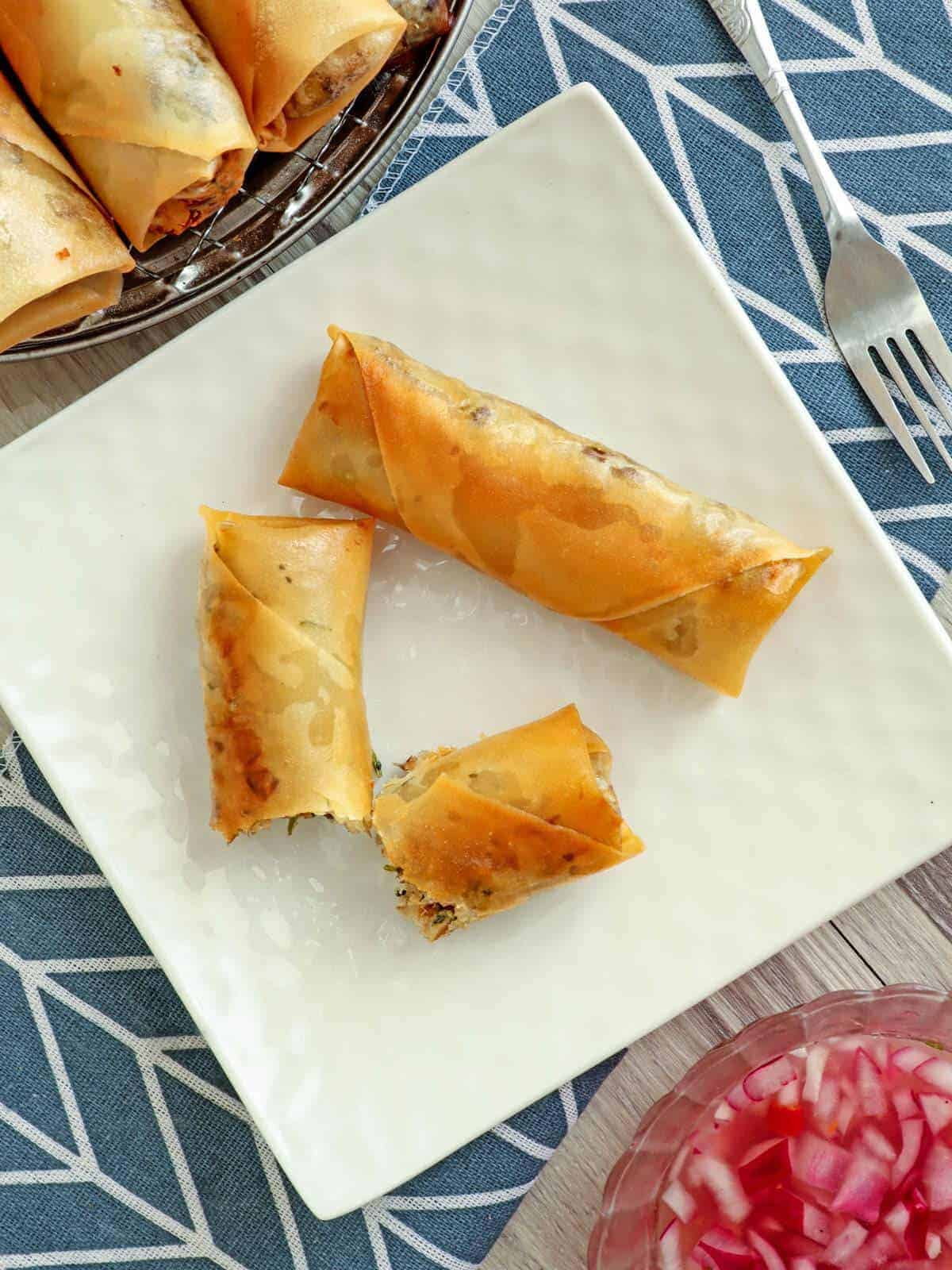 top view of crispy Fish Lumpia on a white square platter