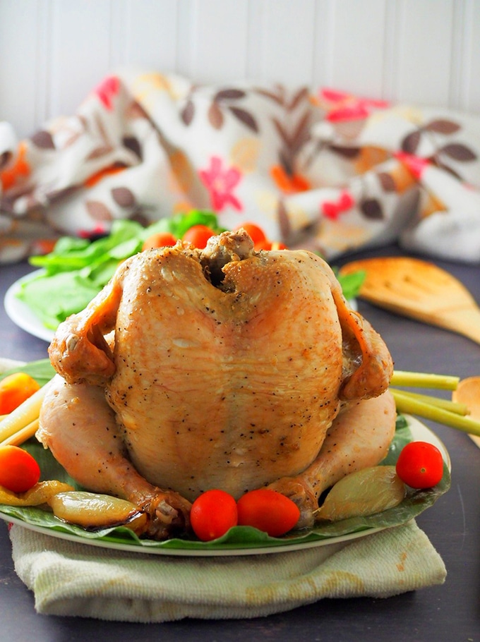 Pinaupong Manok on a serving platter with cherry tomatoes as garnish