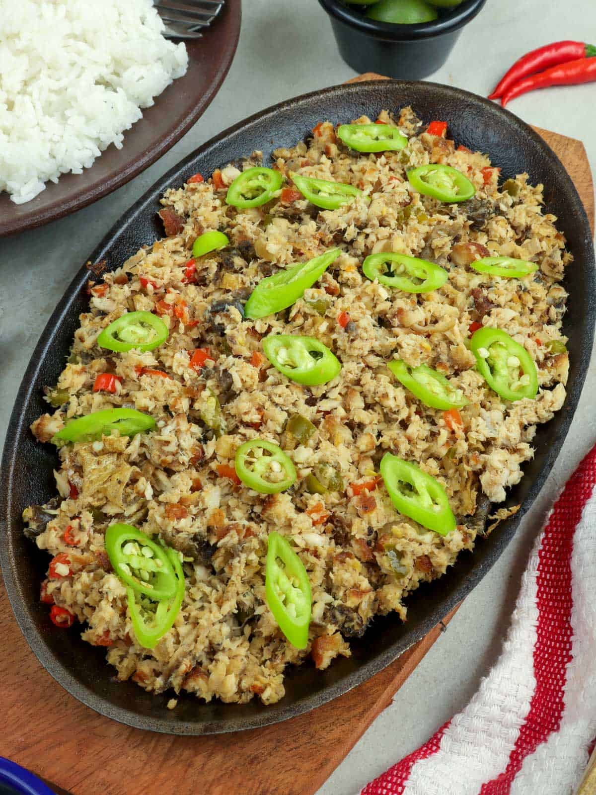 fish sisig on a sizzling cast iron plate