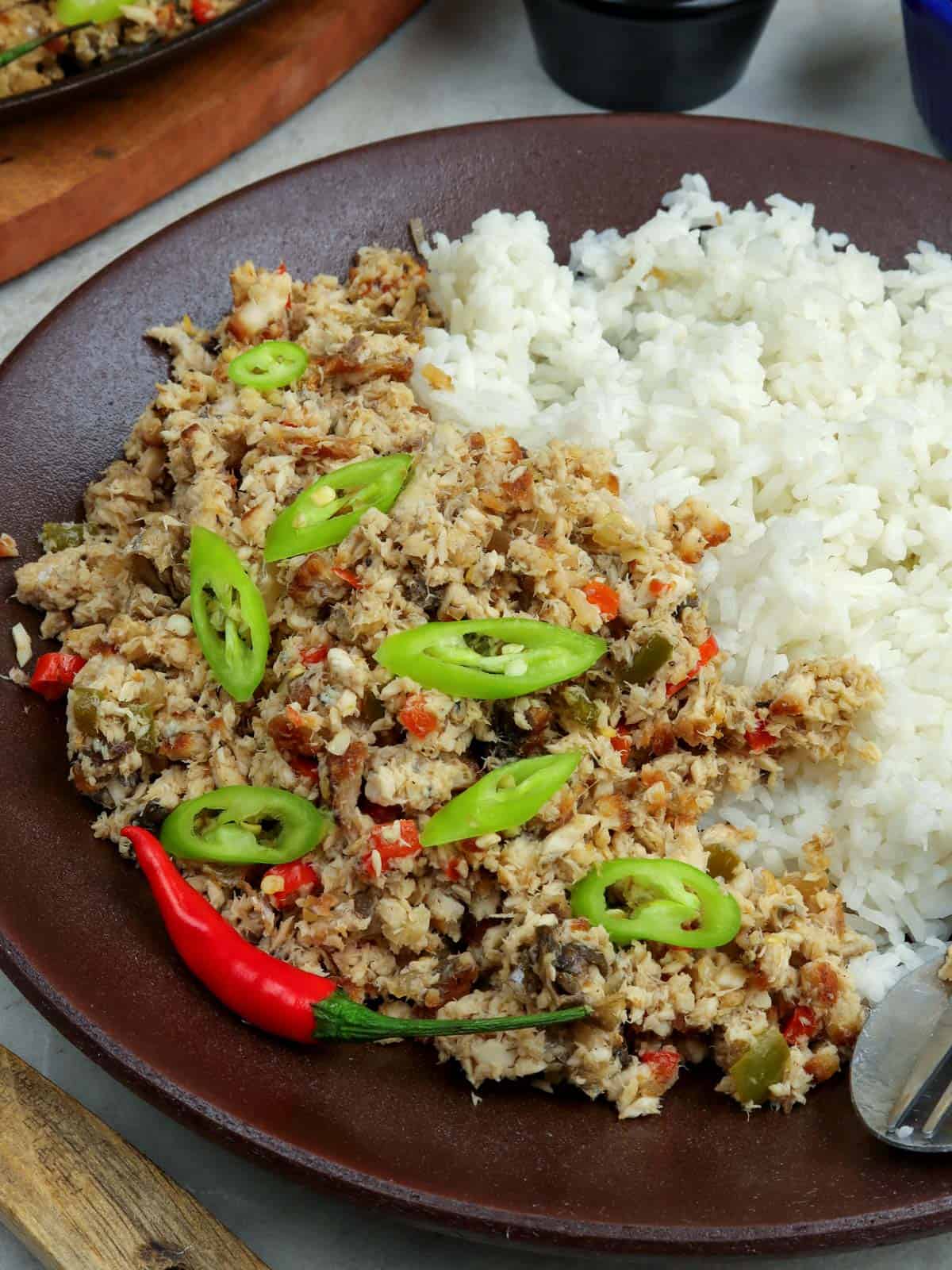 bangus sisig with rice on a plate