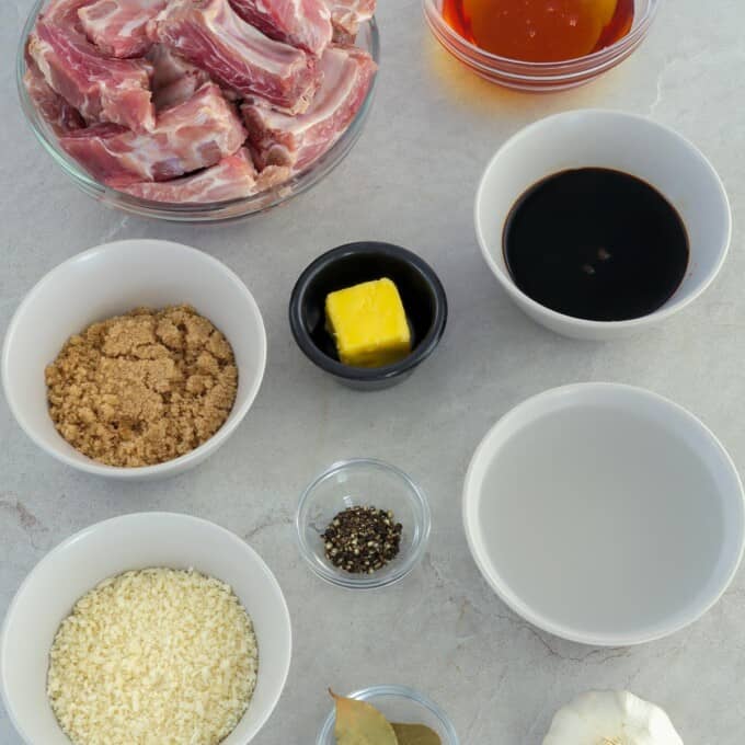 sliced pork ribs, butter, brown sugar, soy sauce, breadcrumbs, vinegar, salt, pepper, honey, bay leaves, garlic