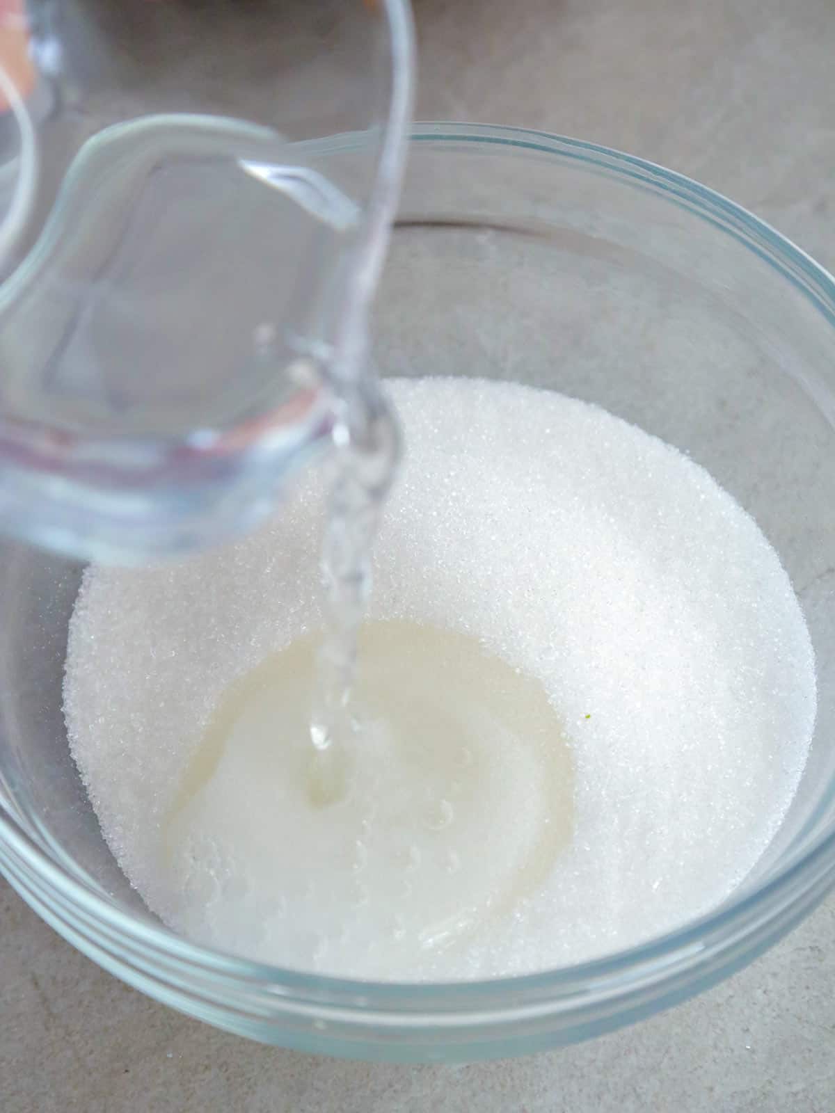 pouring water on a bowl of sugar
