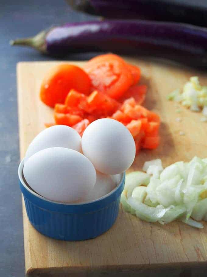 eggs, eggplant, chopped tomatoes, onions, and garlic