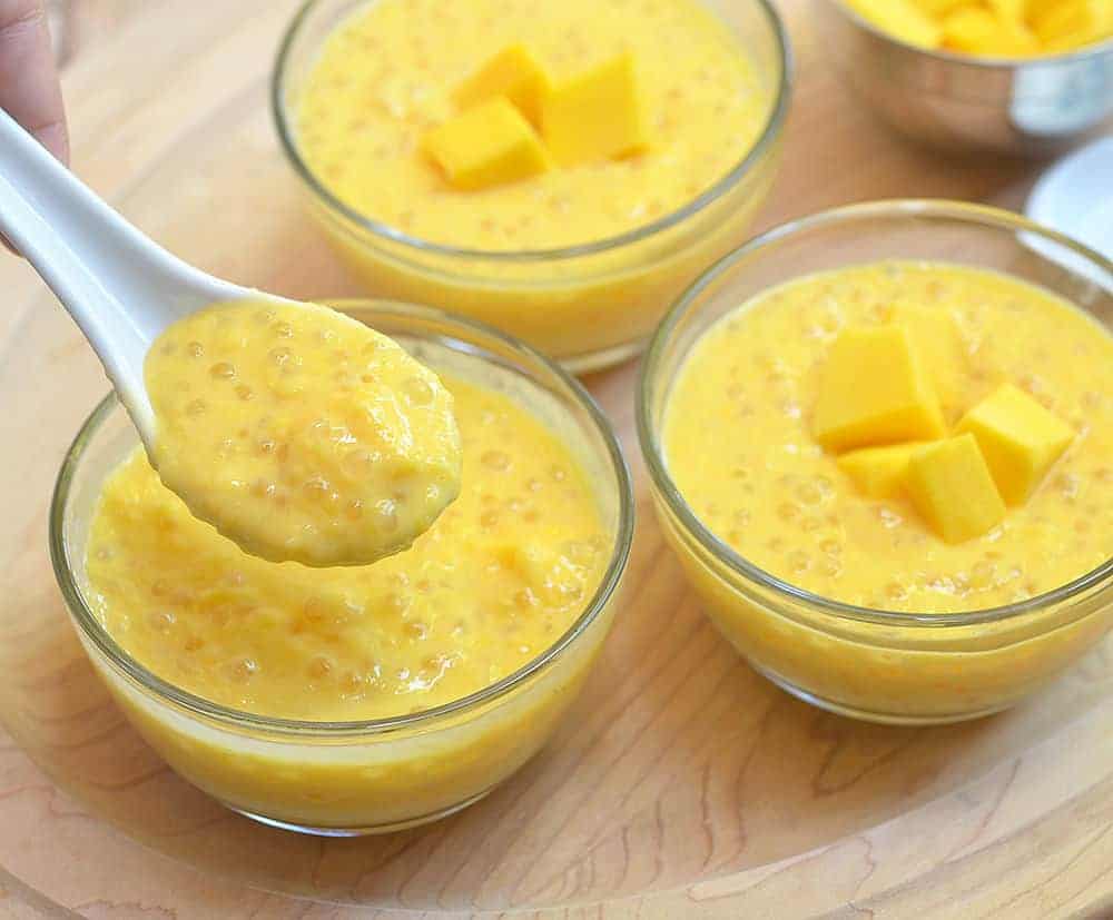 Mango Sago made with mangoes, tapioca pearls, and milk. Sweet, tangy and creamy, it's a summer dessert you'd want all year long!