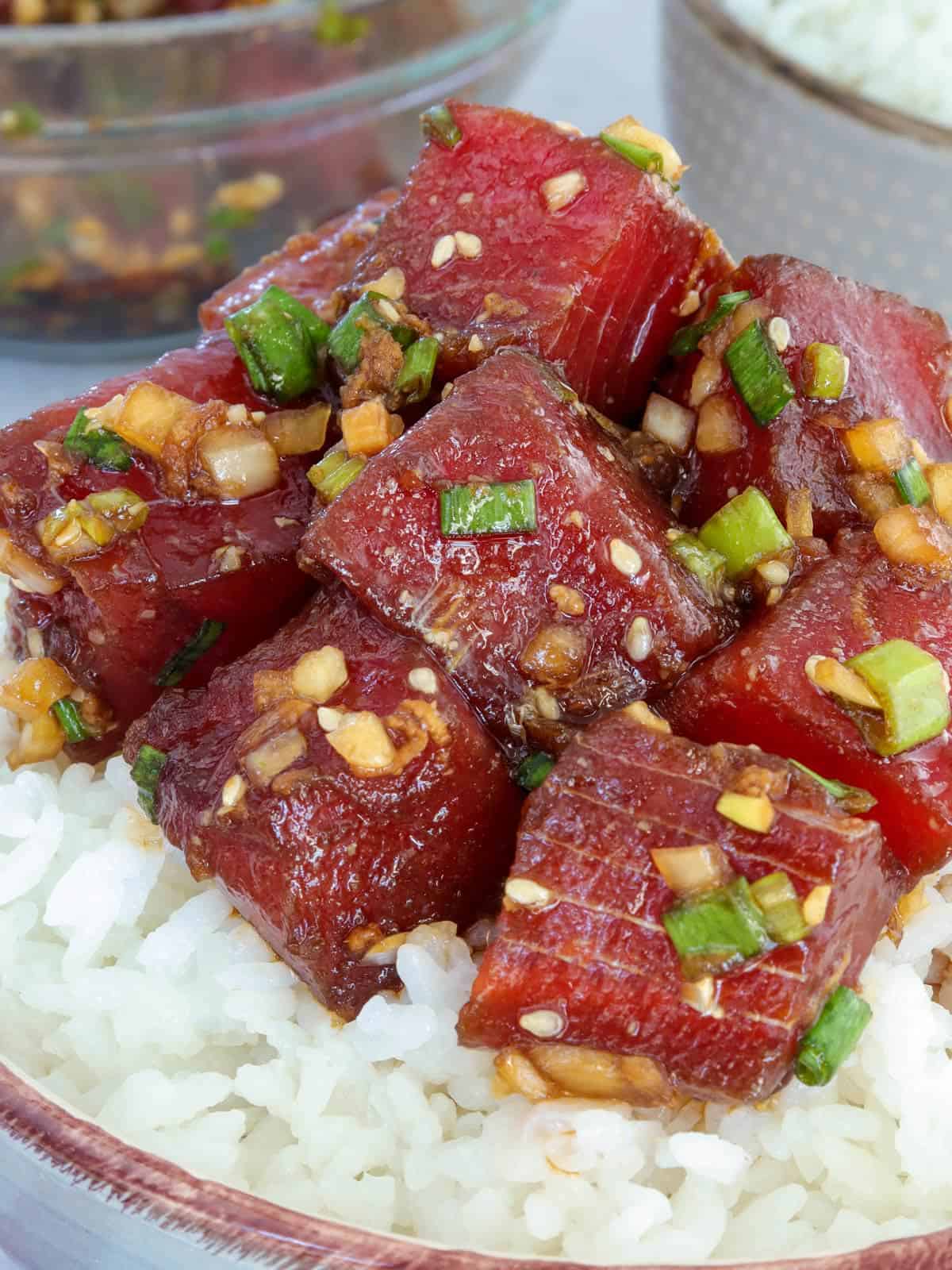 Ahi shoyu poke over sushi rice in a bowl 