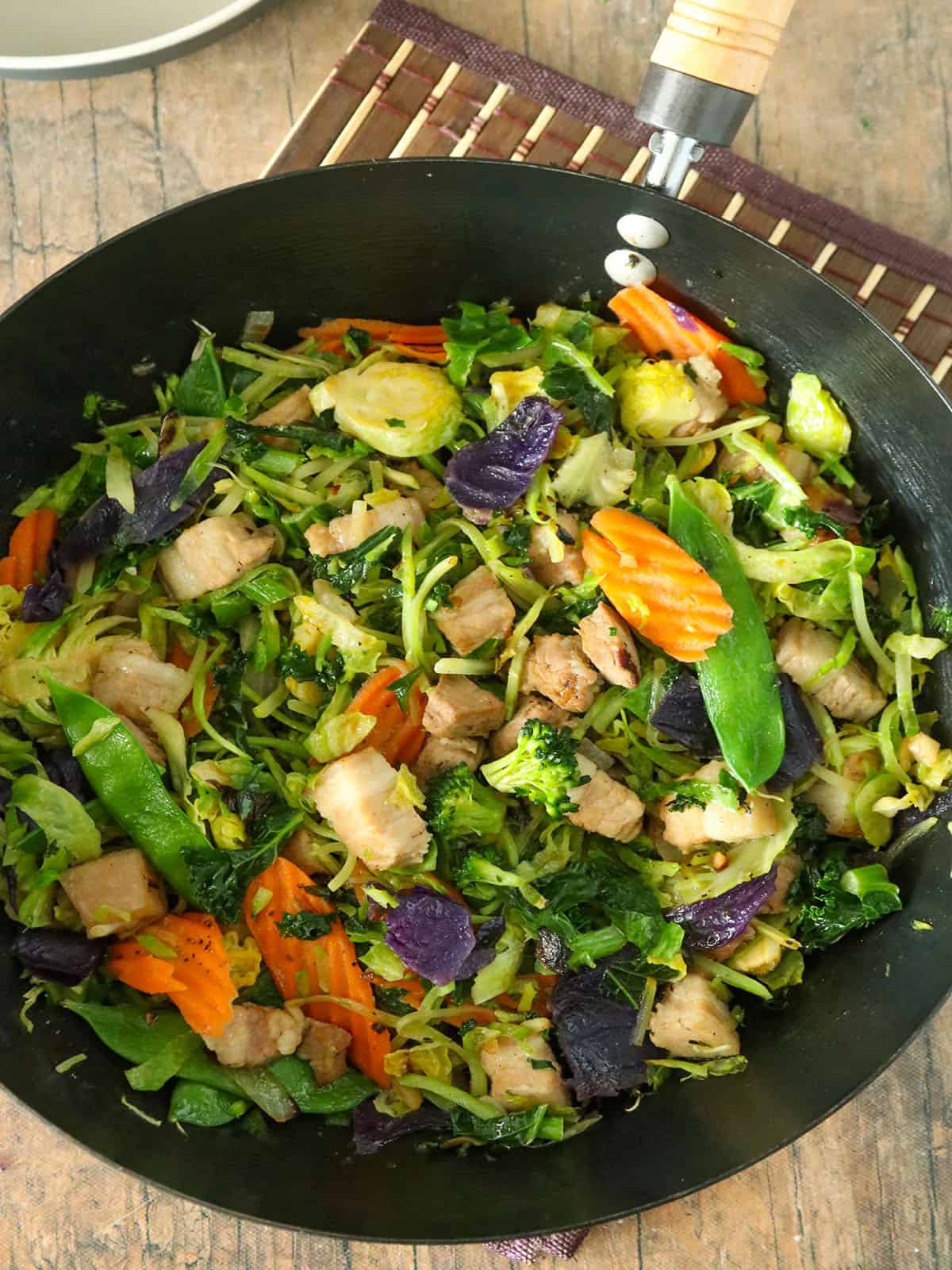 Asian Stir-fry with vegetables and tender pork strips in a wok
