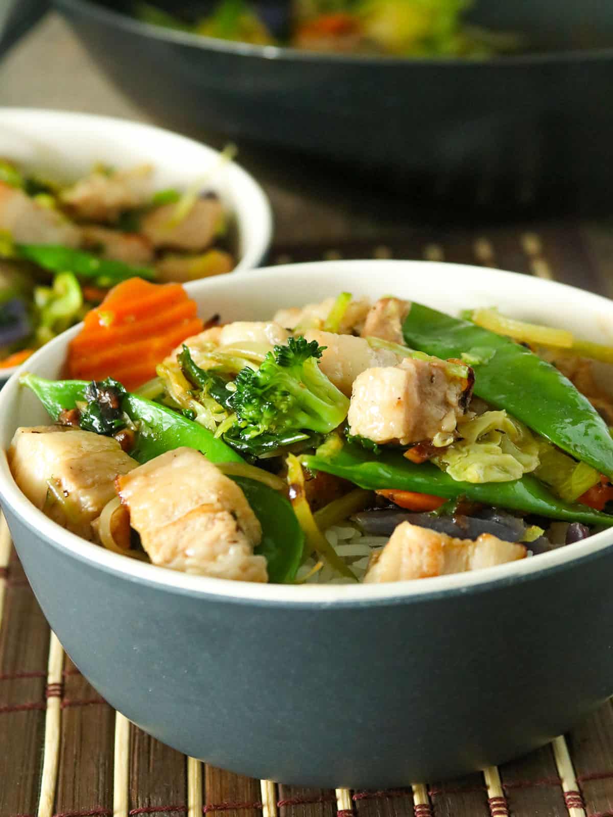 vegetable stir-fry in a bowl over steamed rice