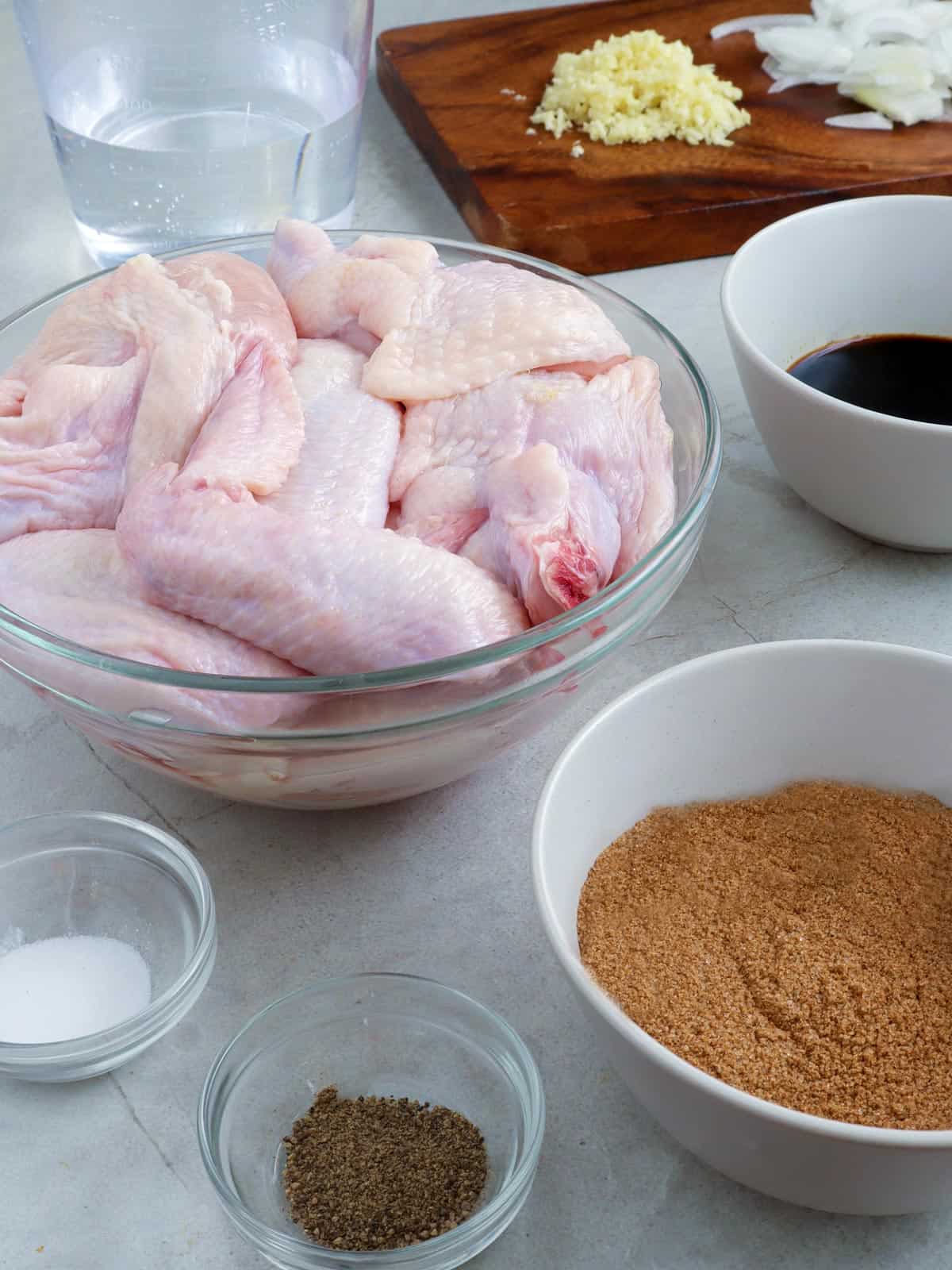 tamarind powder, soy sauce, chopped garlic, sliced onions, and chicken wings