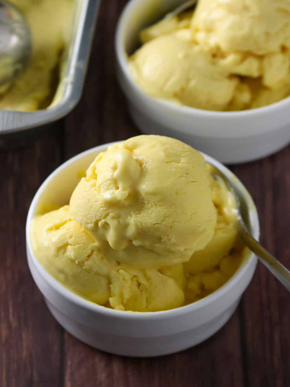 mango ice cream in white serving bowls