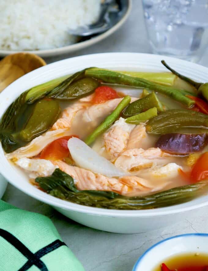 salmon and vegetable sour soup in a bowl