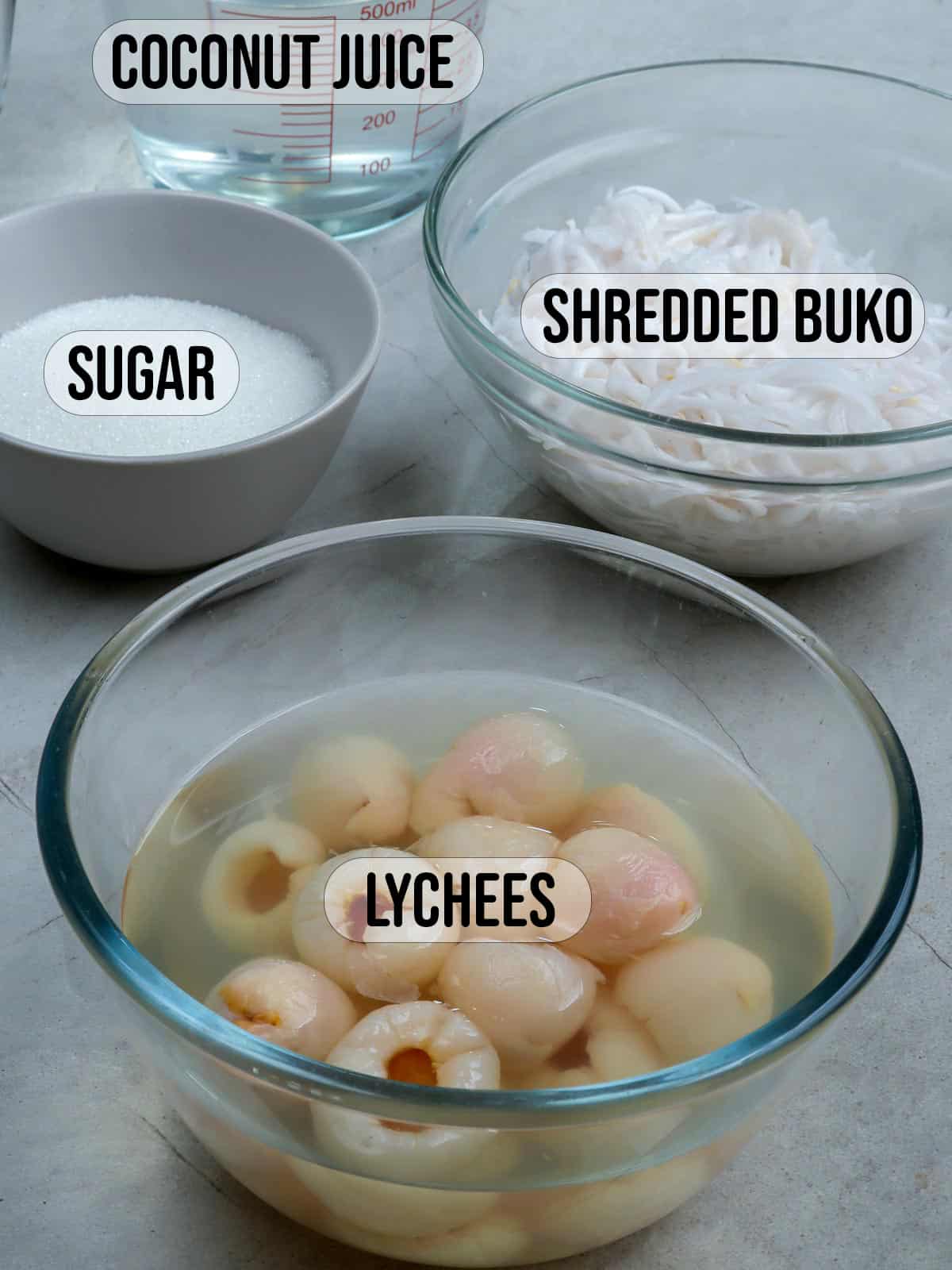 sugar, coconut juice, shredded buko , lychee in syrup in bowls.
