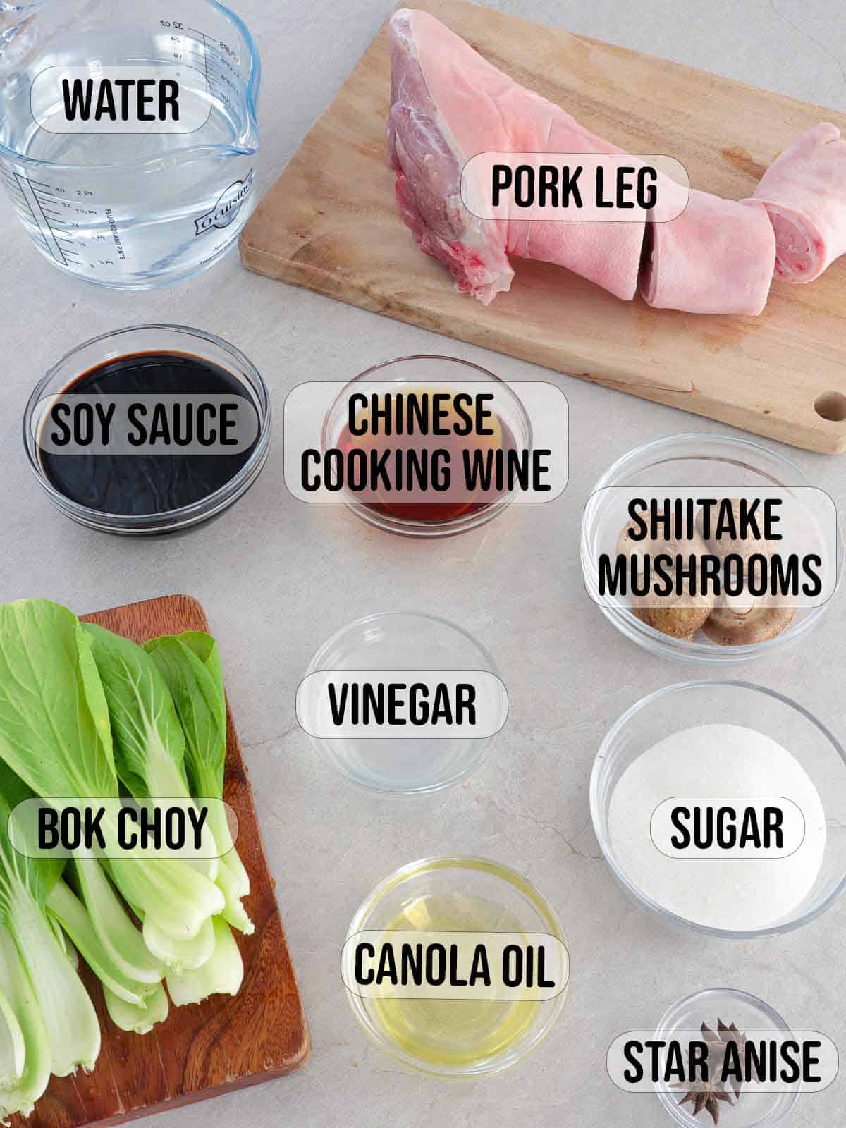 whole pork leg, soy sauce, Chinese cooking wine, sugar, shiitake mushrooms, bok choy, water, oil, star anise, vinegar in bowls.