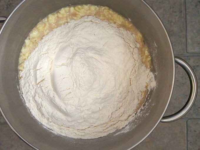 milk mixture and flour with yeast mixture in a stand mixer bowl