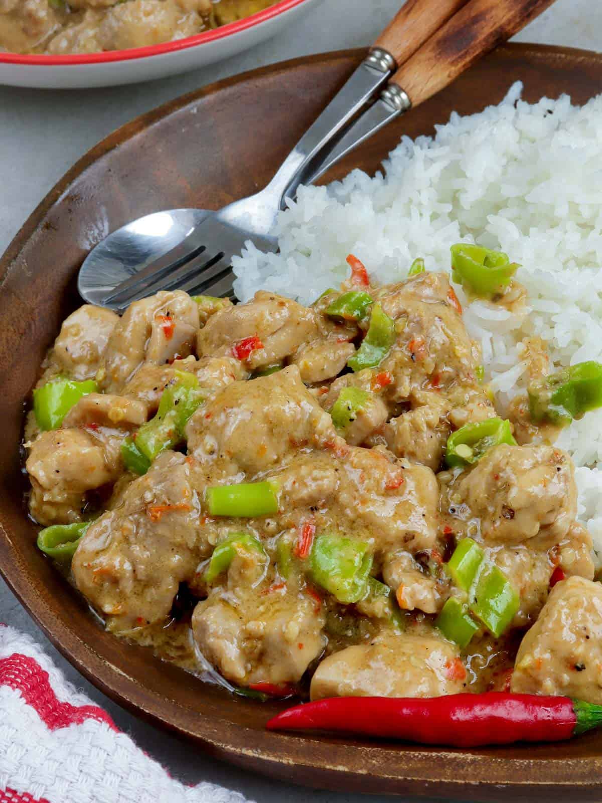 Chicken Bicol Express over steamed rice on a white plate