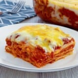 Cheesy lasagna with bechamel sauce layers from a baking dish with a spatula