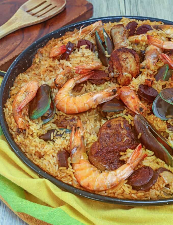 Paella with shrimp, chicken, mussels in a wide pan