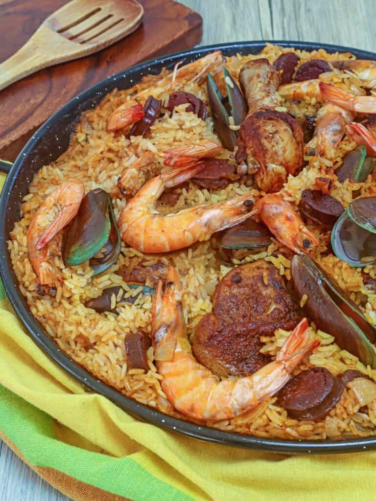 Paella with shrimp, chicken, mussels in a wide pan