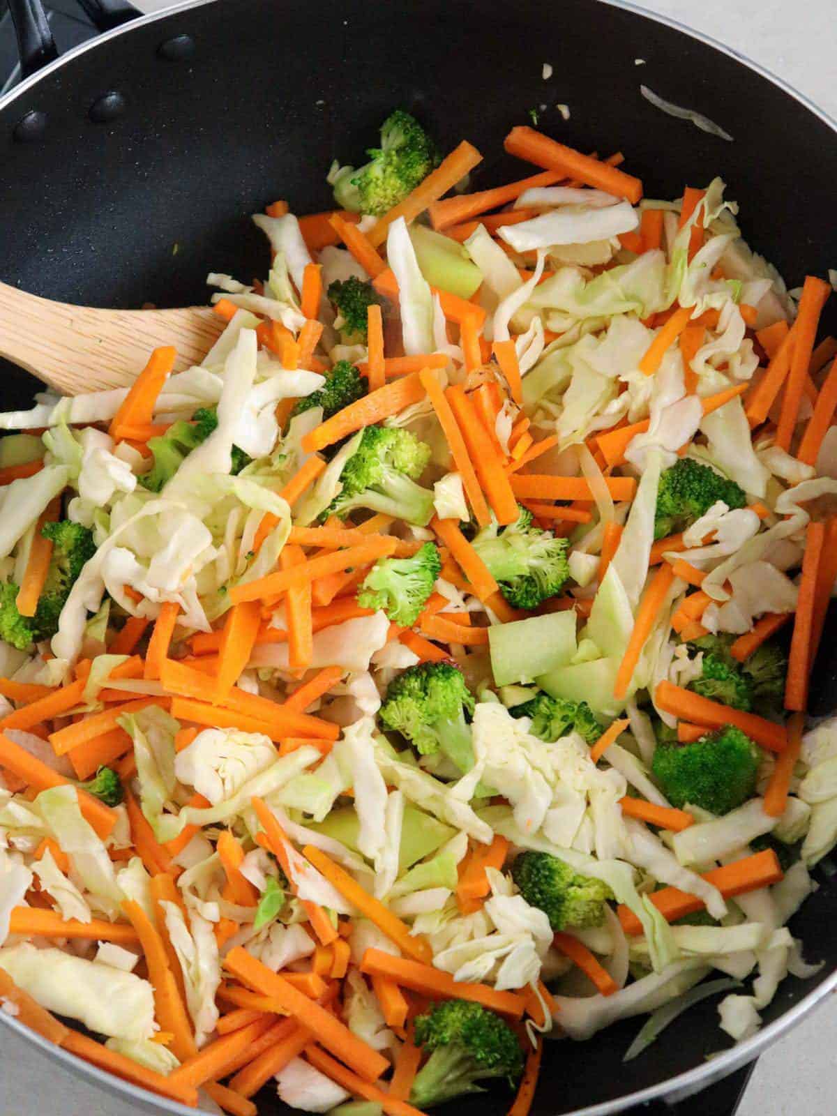 stir-frying assorted vegetables in a skillet