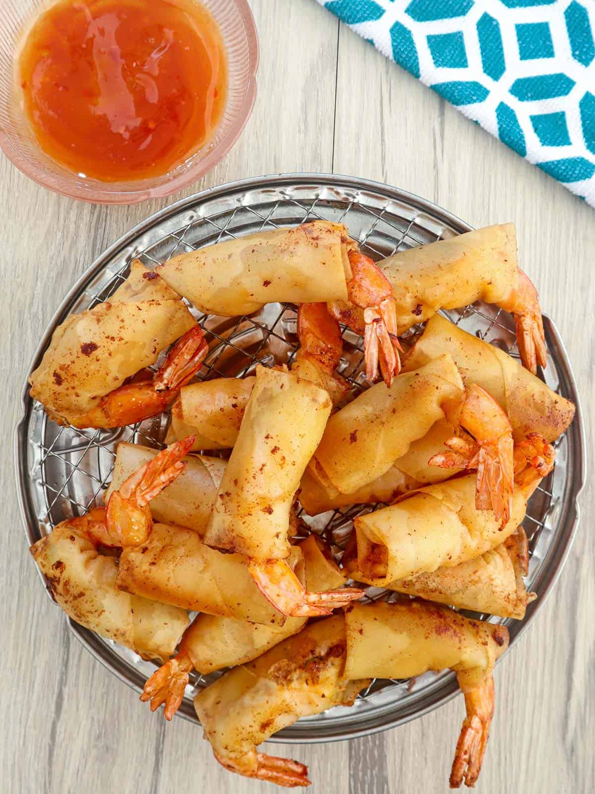 Rellenong Hipon on a serving platter with a side of sweet chili sauce