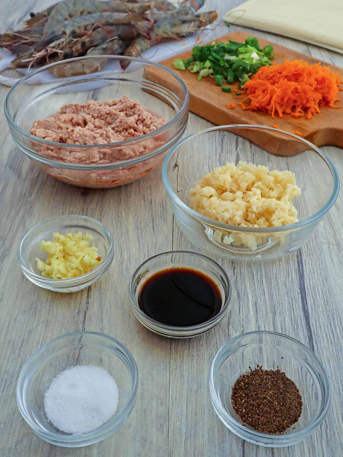 shrimp, ground pork, water chestnuts, garlic, soy sauce, pepper, shredded carrots, chopped green onions