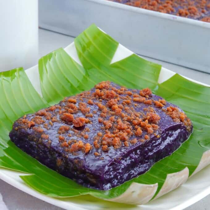 slice of ube kalamay with latik topping on a serving plate