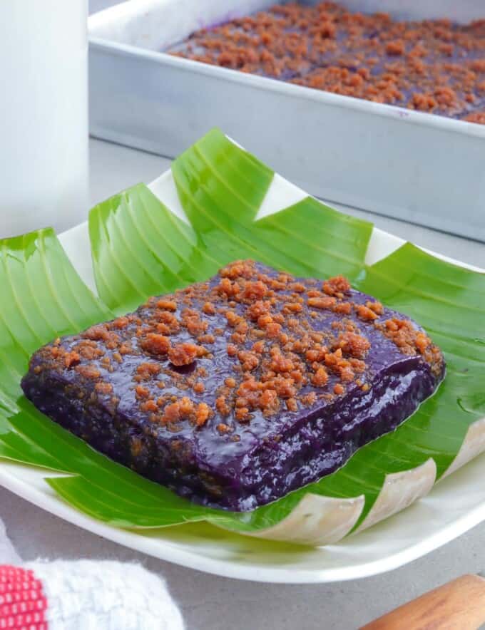 slice of ube kalamay with latik topping on a serving plate