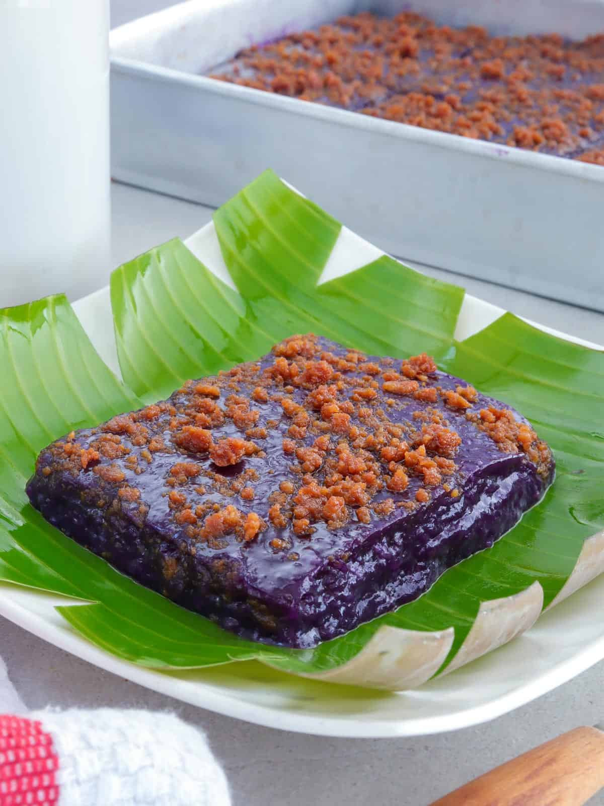 slice of ube kalamay with latik topping on a serving plate