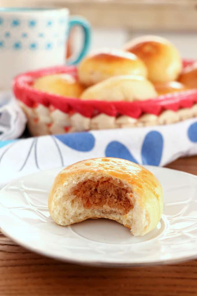 half of coconut bread ona white plate