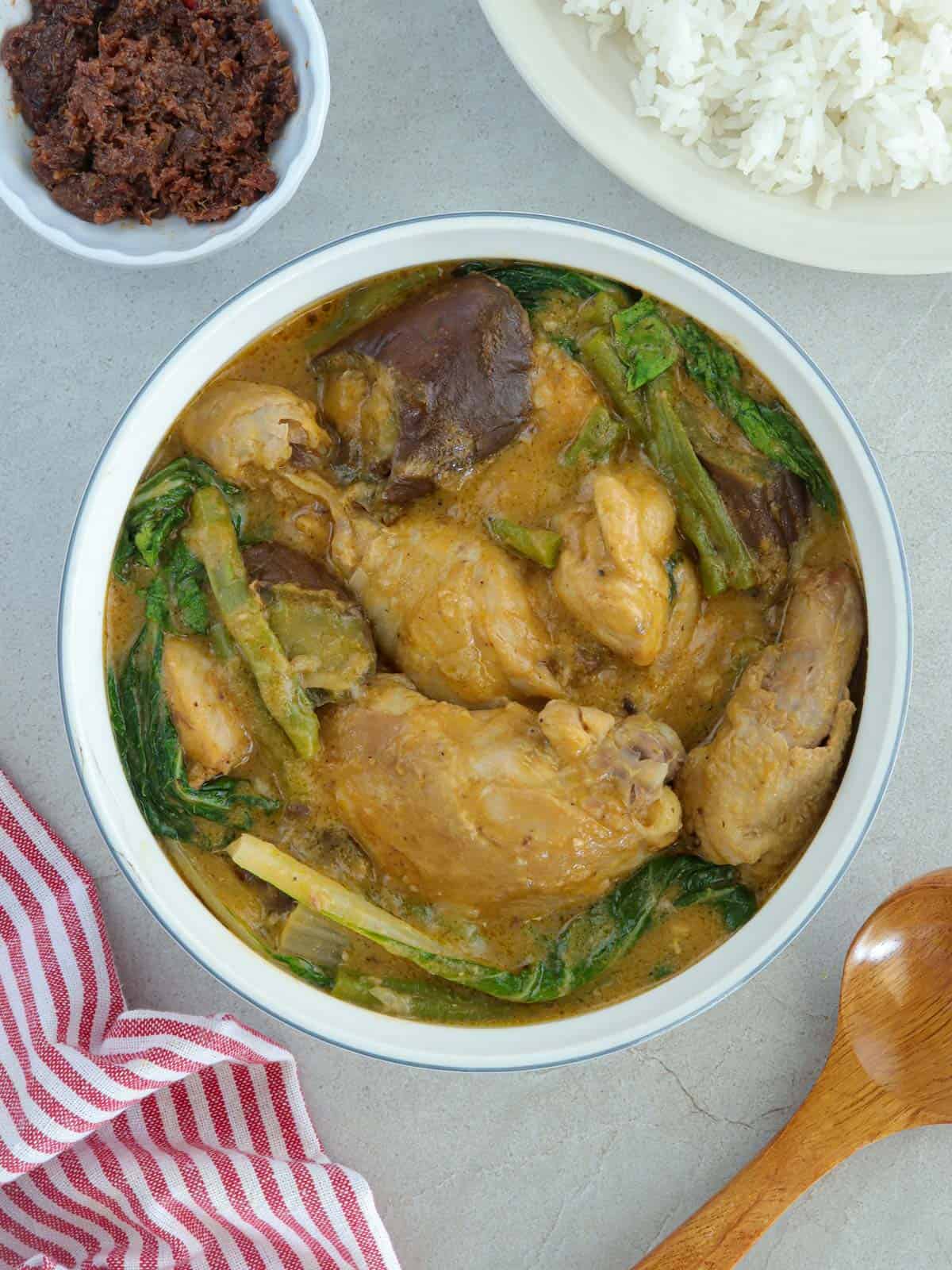 Chicken Kare-Kare in a white serving bowl.