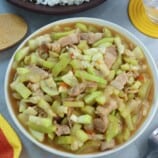 Ginisang Upo with Pork in a white serving bowl with a side of steamed rice