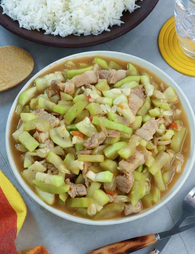 Ginisang Upo with Pork in a white serving bowl with a side of steamed rice