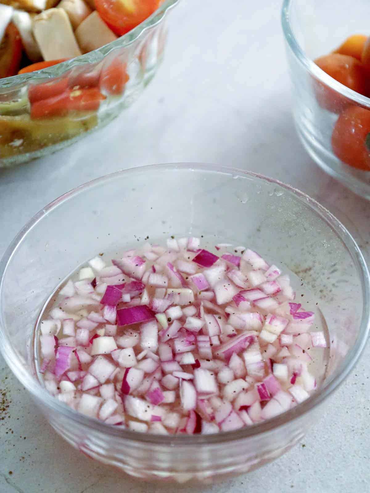 vinegar dressing for ensaladang talong in a clear bowl