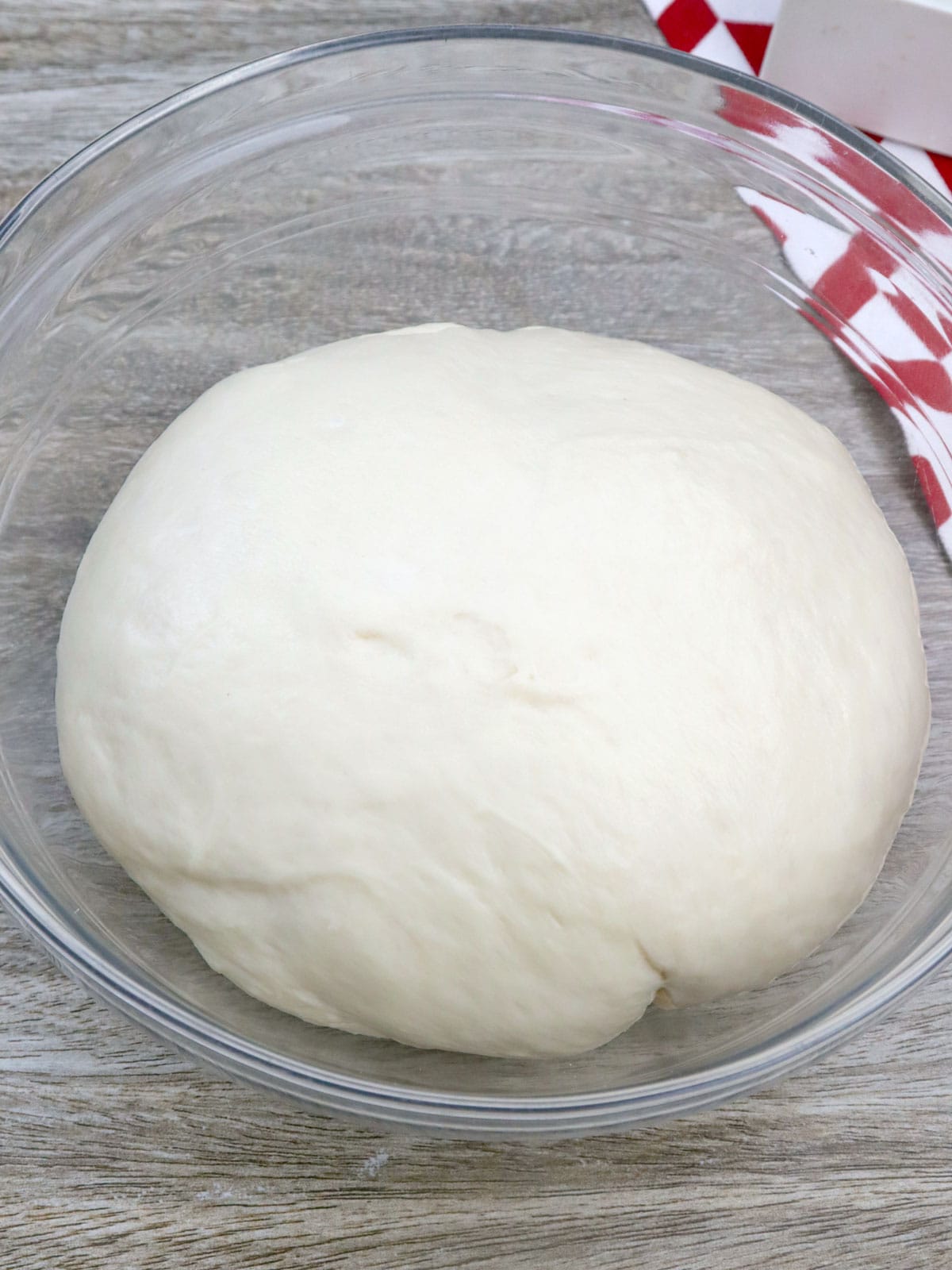 bread dough in a glass bowl.