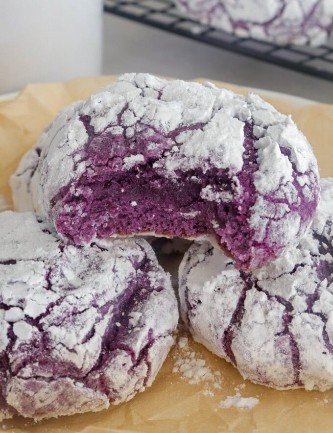 bitten Ube Crinkles on parchment-lined plate.