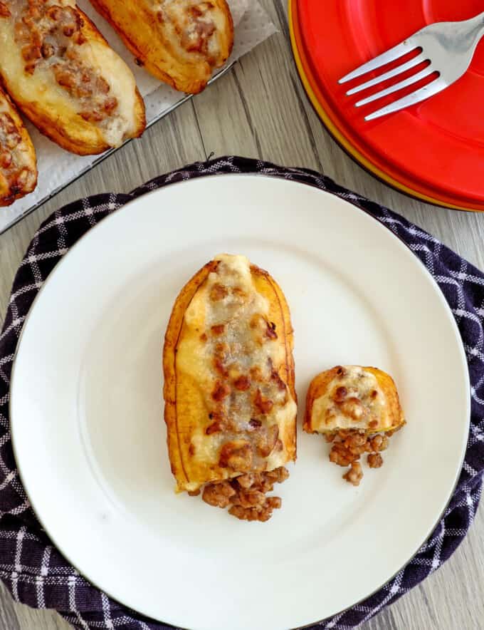 saba bananas stuffed with ground pork and fried until golden on a white plate