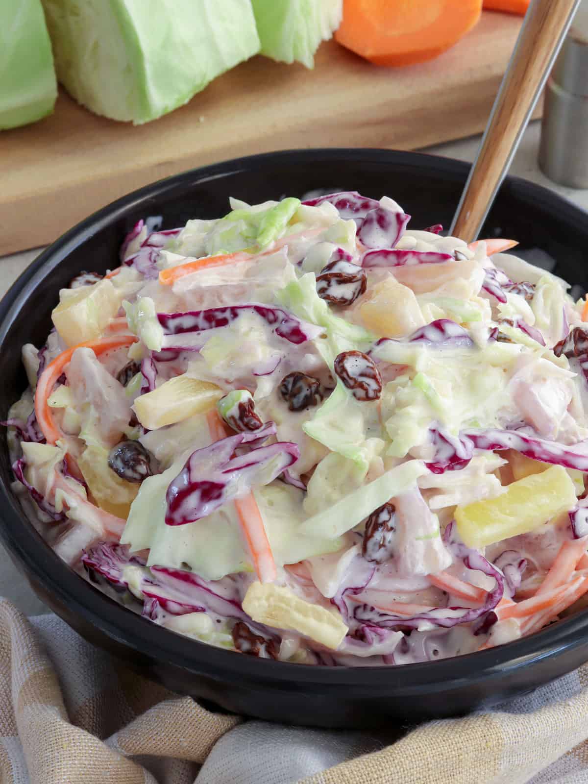 Pineapple Coleslaw in a black serving bowl.