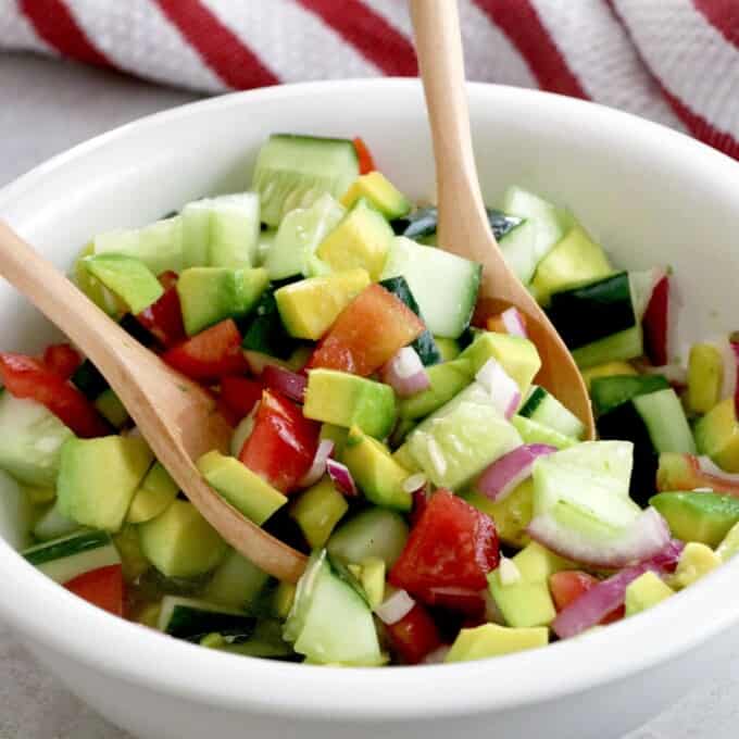 Asian Cucumber Tomato Avocado Salad tossed in a large serving bowl