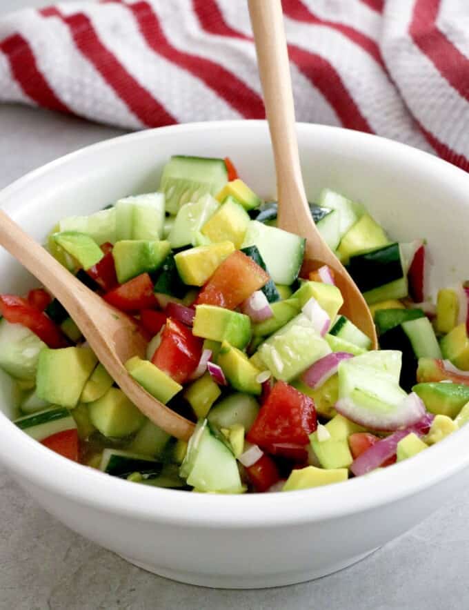 Asian Cucumber Tomato Avocado Salad tossed in a large serving bowl