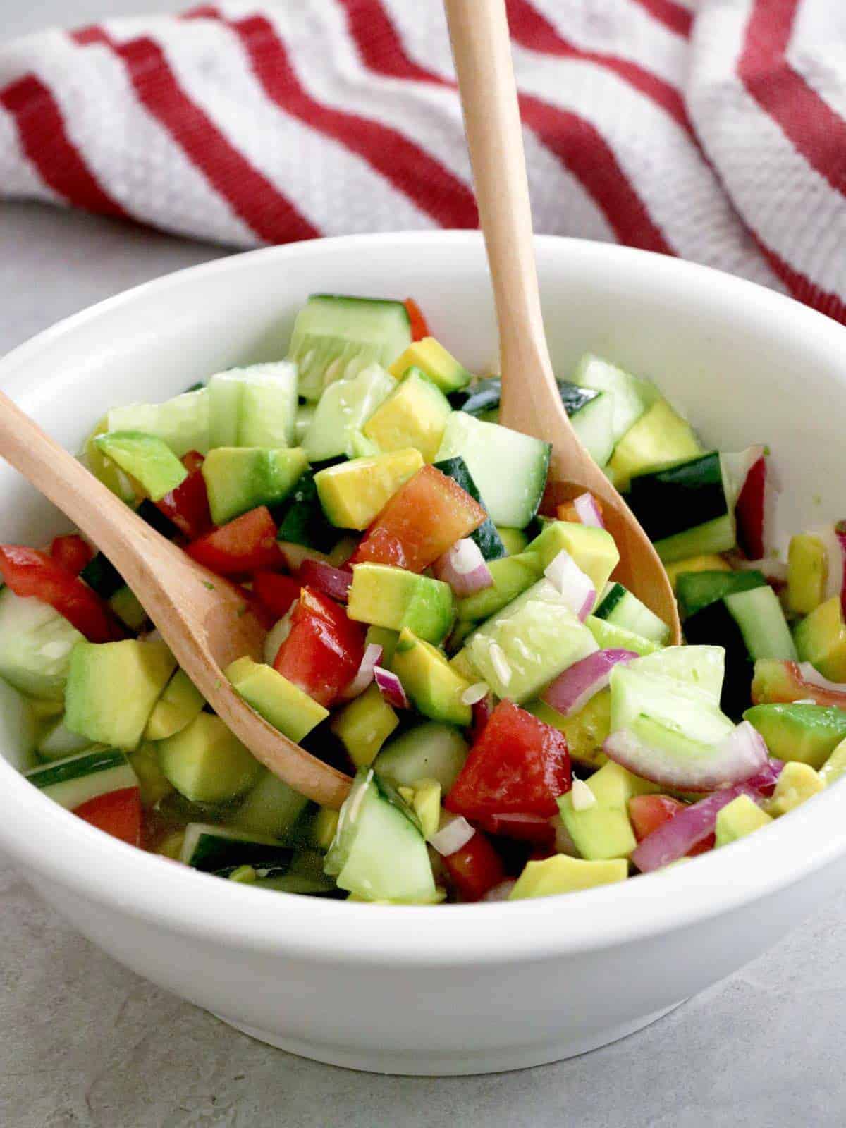 Asian Cucumber Tomato Avocado Salad tossed in a large serving bowl