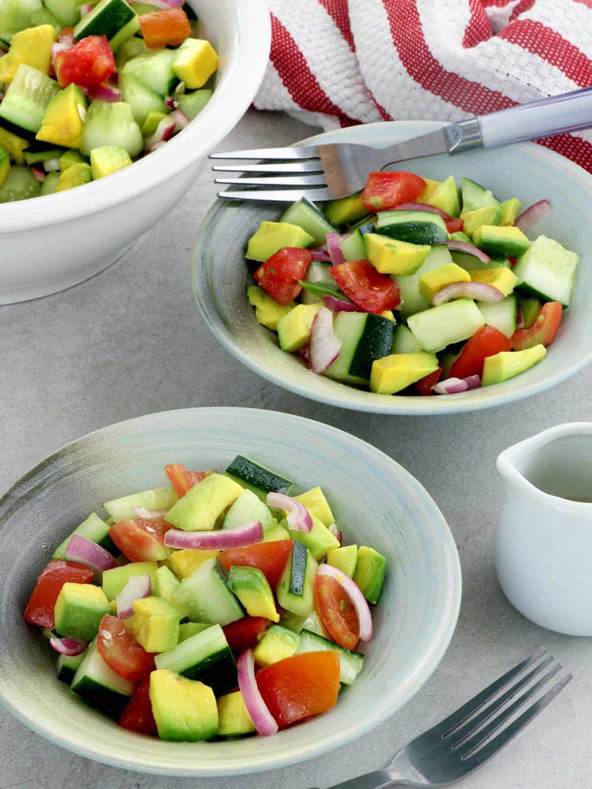 cucumber avocado salad in serving bowls