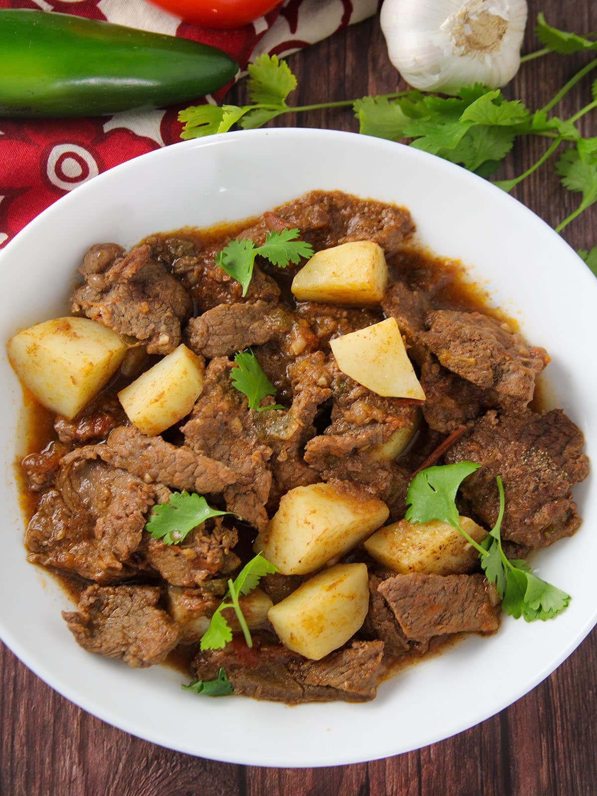 Mexican-style braised beef and potatoes in tomato sauce stew in a serving bowl
