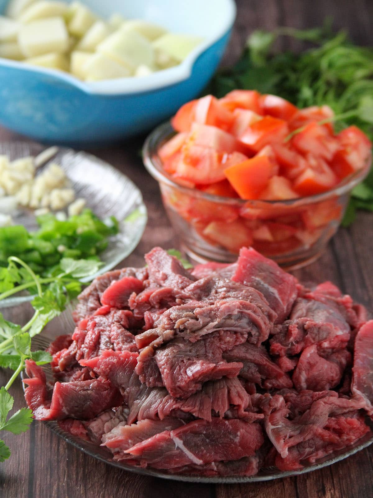 sliced beef, chopped tomatoes, potatoes, garlic, onions, jalapeno peppers