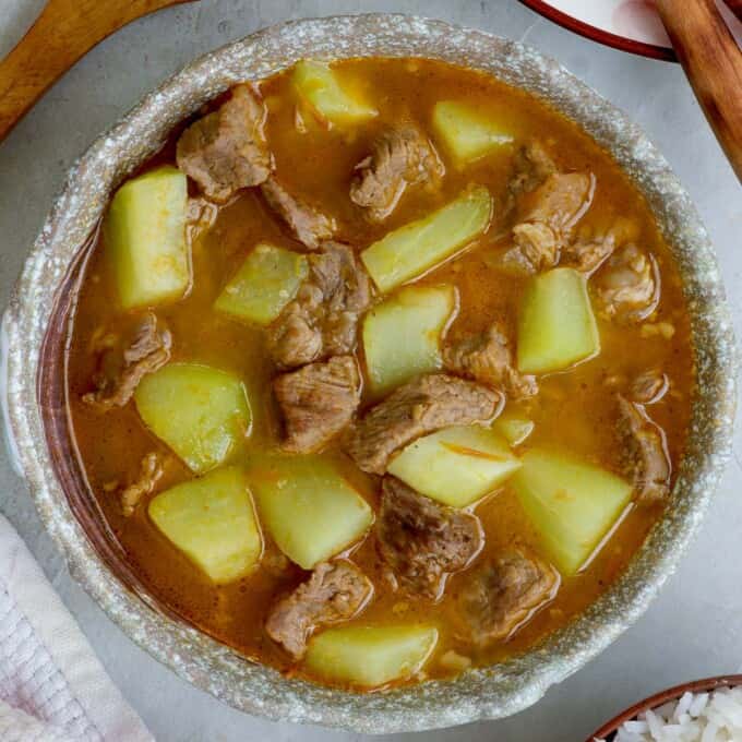 Picadillo Soup in a bowl with steamed rice on the side