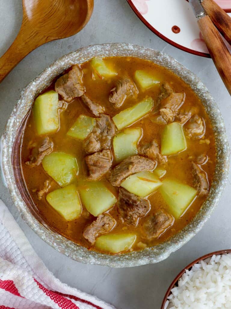 Picadillo Soup in a bowl with steamed rice on the side