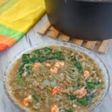 Ginisang Munggo at Sotanghon in a clear glass bowl with a pot of munggo on the side